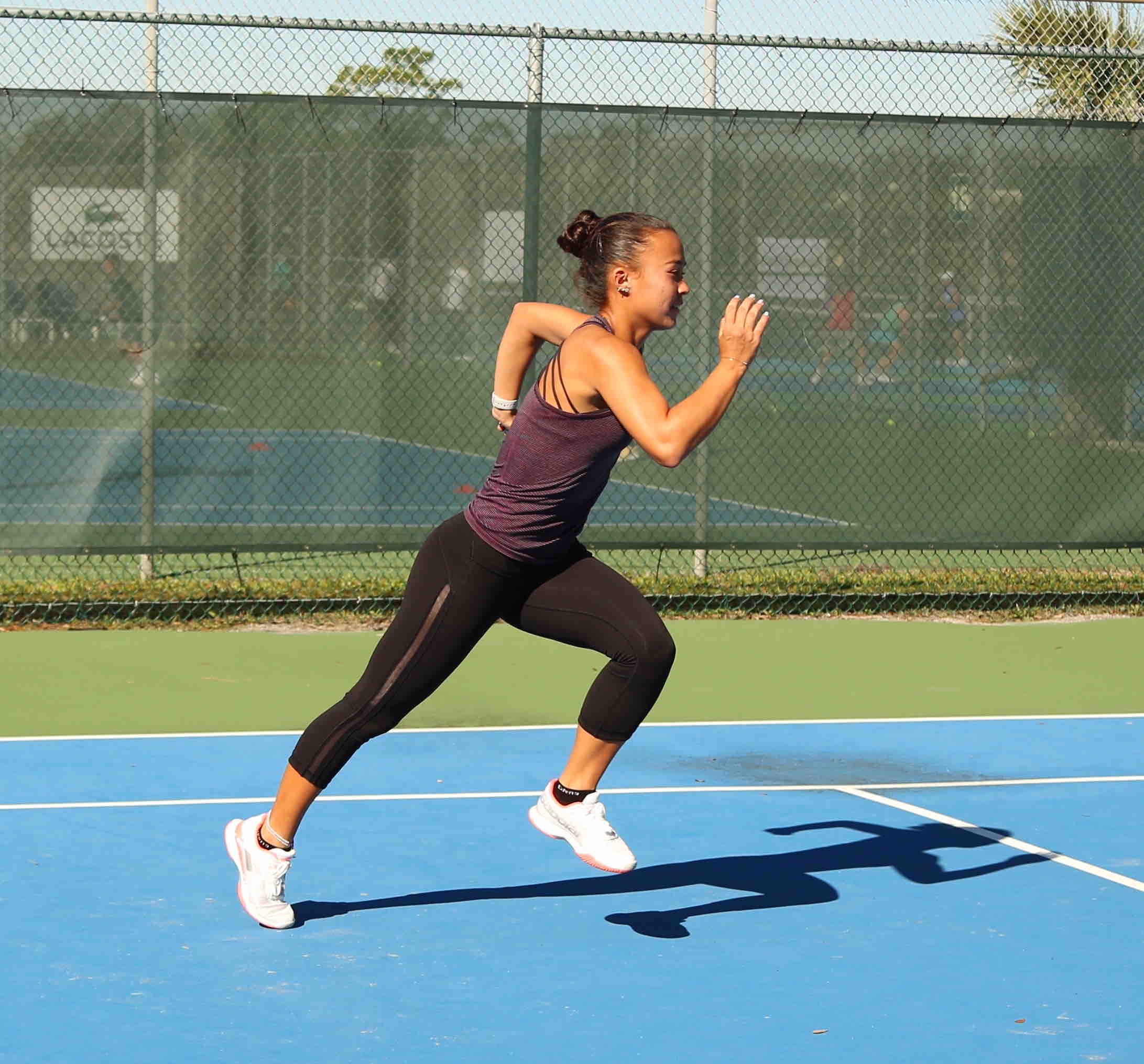 Athlete running on a track for conditioning and endurance.