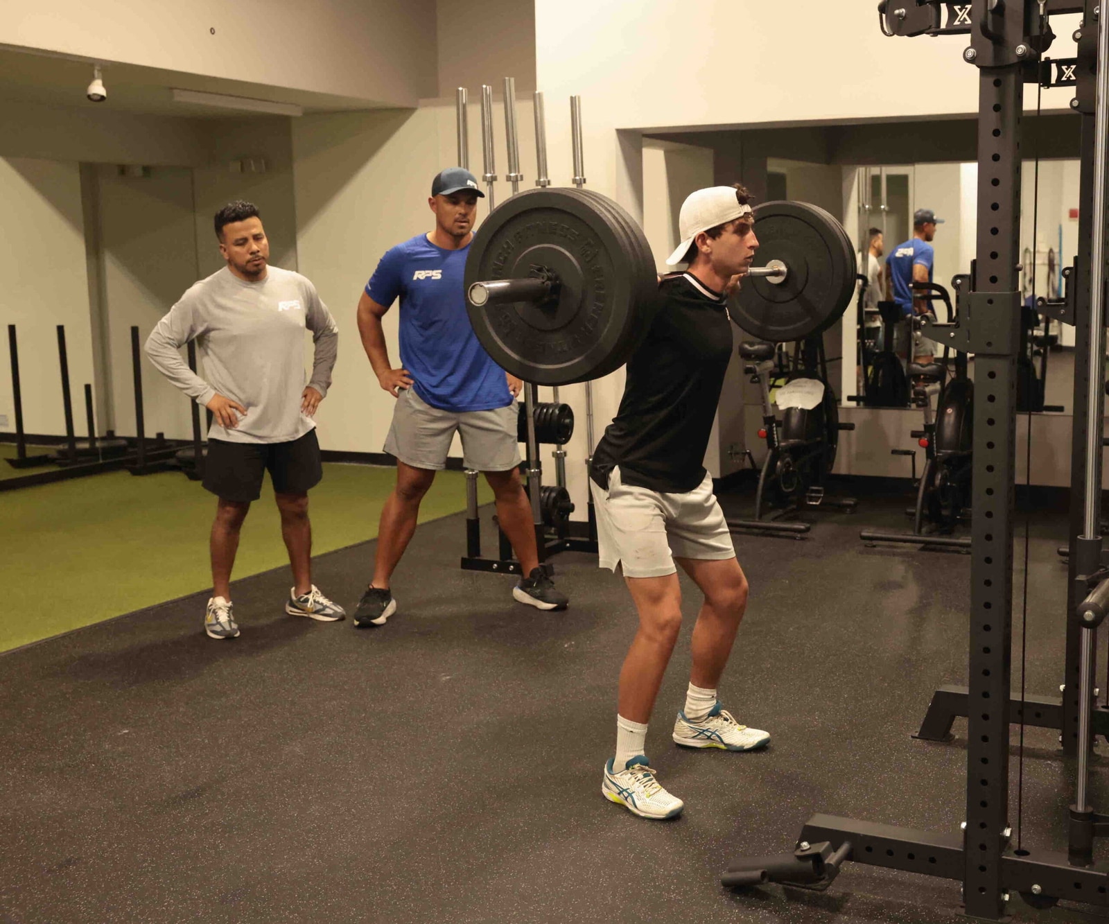 Athlete performing a barbell squat for strength training.