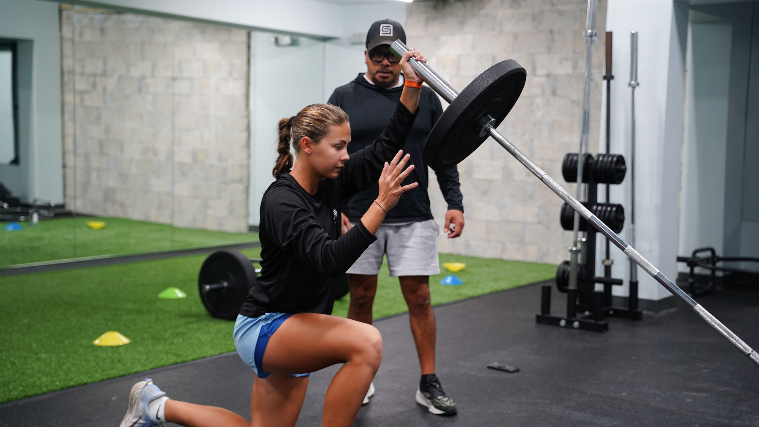 Student athlete weight training with coach