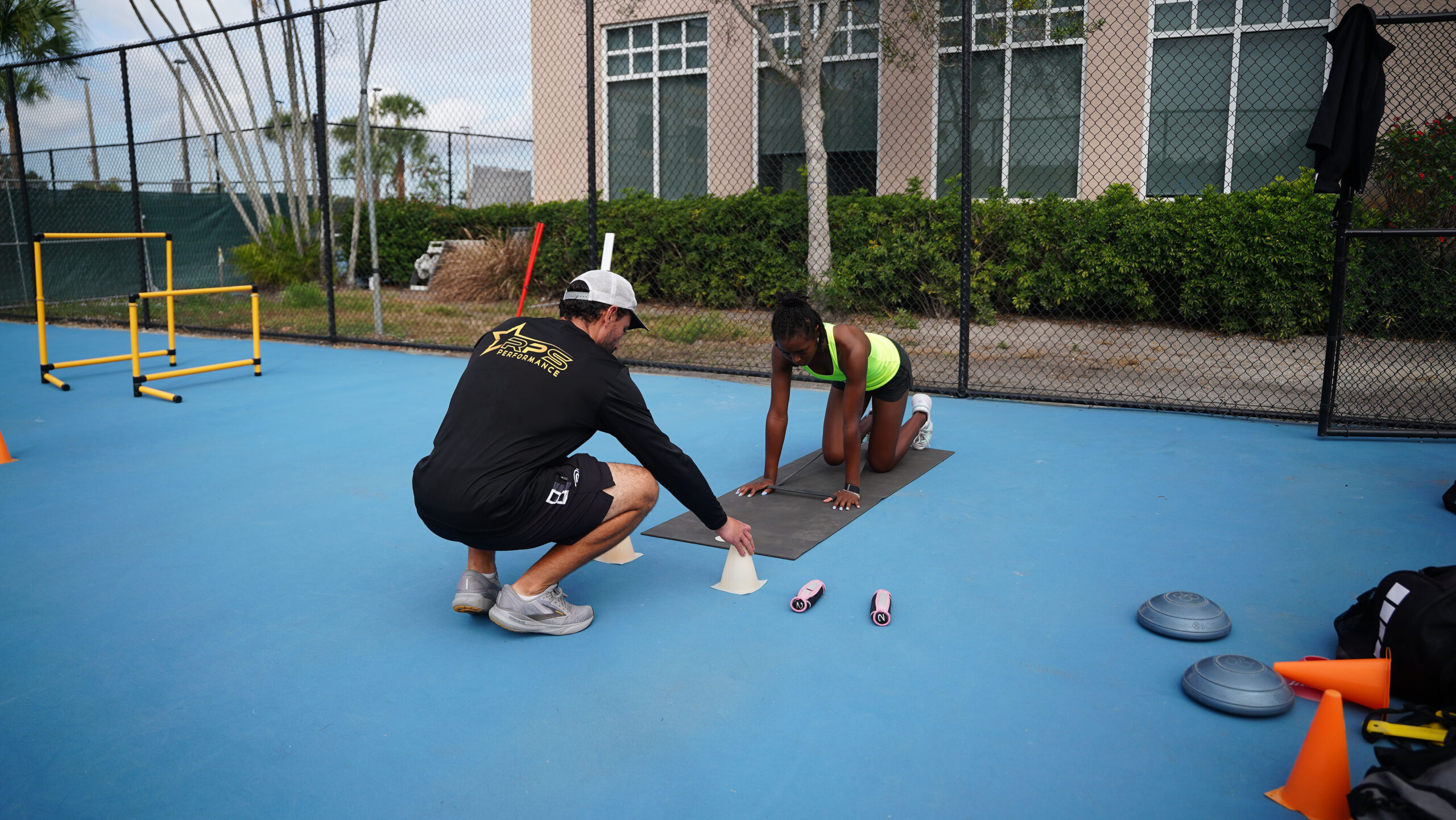 Coach providing guidance to an RPS tennis player.